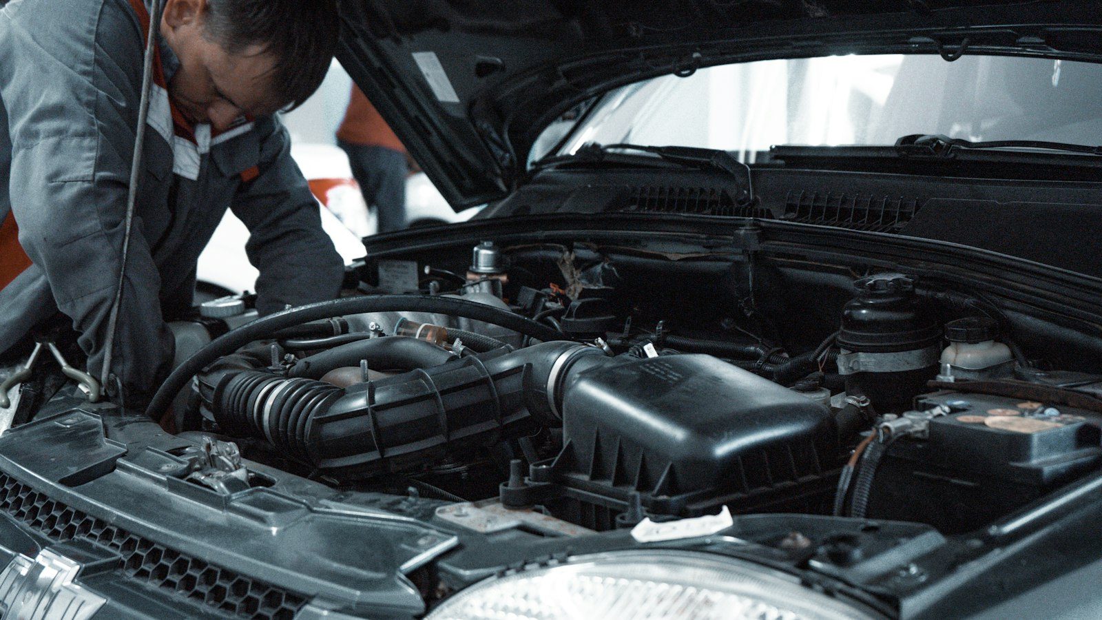 Technician inspecting an engine compartment